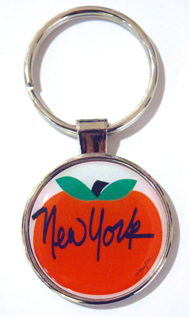 Big Apple New York Keychain by artist Mary Ellis.  This metal New York keyring measures 1.25 inches by 2.25 inches and features a hard resin dome and shiny reflective metal backing.  